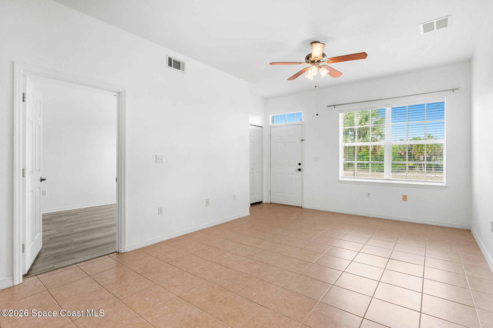 110 Turpial Way, Unit 106 Melbourne, FL 32901 - Photo 11 of 50 a view of an empty room with a window