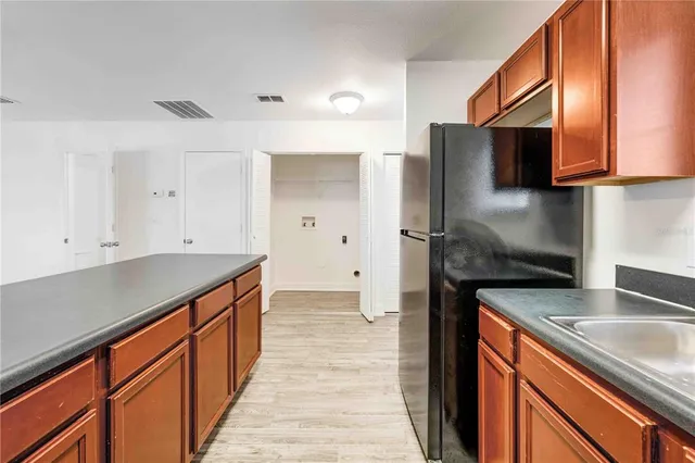 a bathroom with a granite countertop toilet and a shower