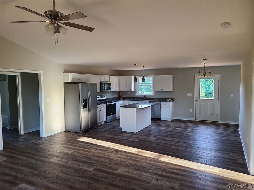 363 Hawkins Farm Road Bumpass, VA 23024 - Photo 4 of 9 a kitchen with stainless steel appliances kitchen island wooden floors and white cabinets