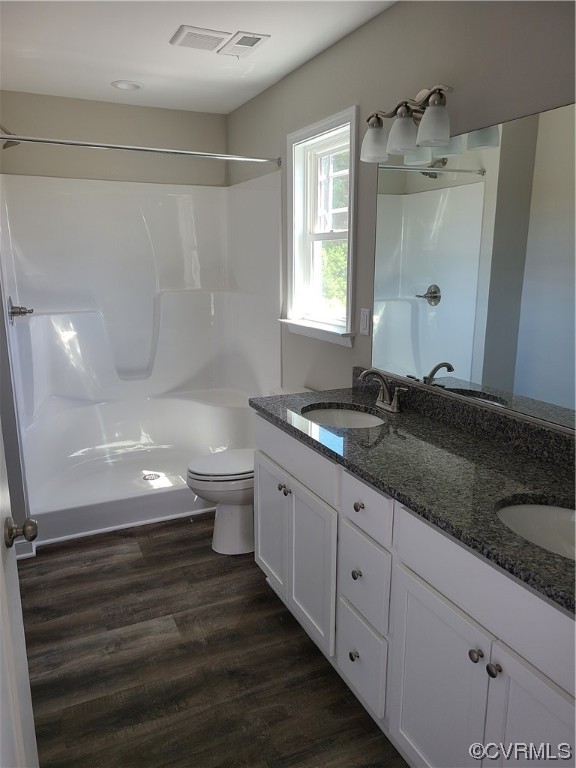 363 Hawkins Farm Road Bumpass, VA 23024 - Photo 8 of 9 a large bathroom with a granite countertop sink a toilet a shower and a mirror