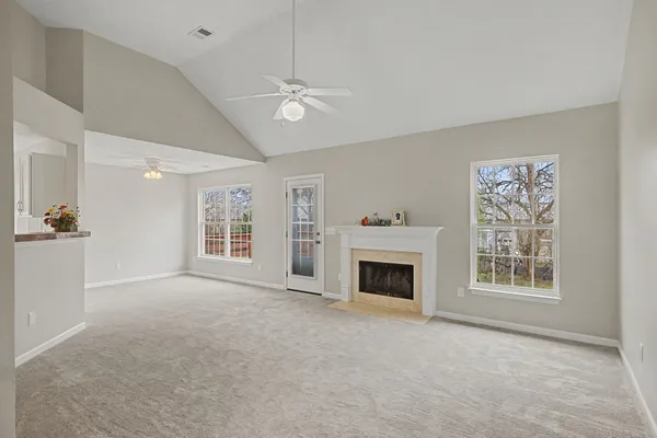 a view of livingroom with an empty space and a fireplace