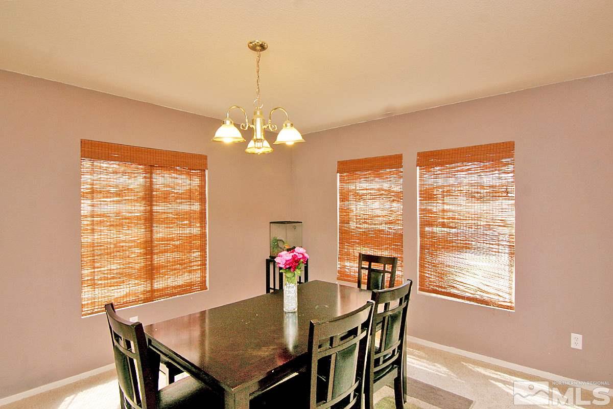7731 Corso Street, Unit RENO Reno, NV 89506 - Photo 3 of 17 a view of a dining room with furniture window and outside view