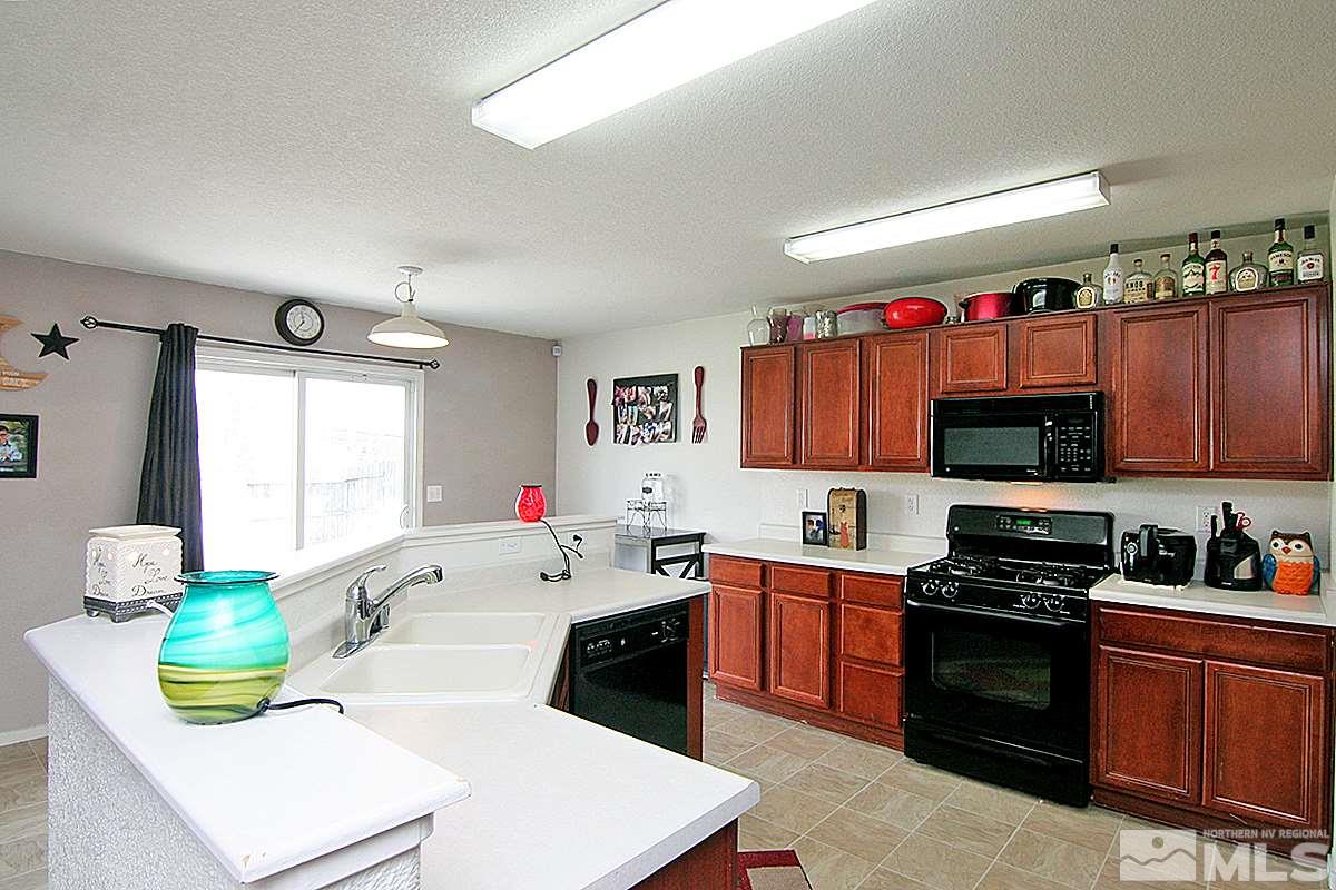 7731 Corso Street, Unit RENO Reno, NV 89506 - Photo 5 of 17 a kitchen with a sink a stove and cabinets