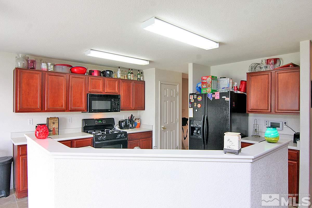 7731 Corso Street, Unit RENO Reno, NV 89506 - Photo 6 of 17 a kitchen with a refrigerator and a sink