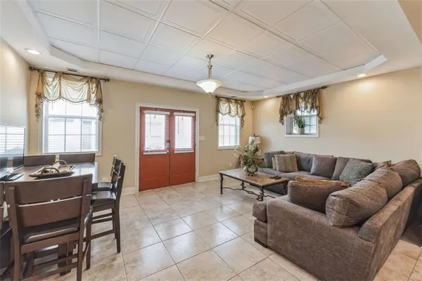 a living room with furniture a dining table and a window