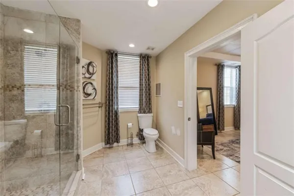 a bathroom with a glass shower door