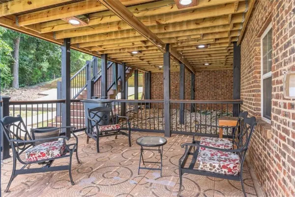 a view of a chairs and table in the patio