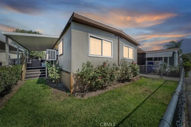 a front view of house with a garden