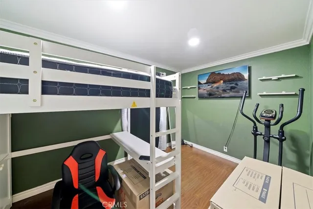 a bedroom with bed and a chandelier