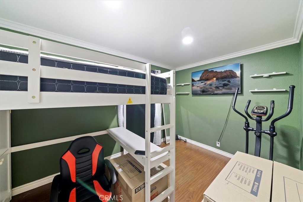 250 North Linden Avenue, Unit 327 Rialto, CA 92376 - Photo 21 of 27 a bedroom with a bed and furniture