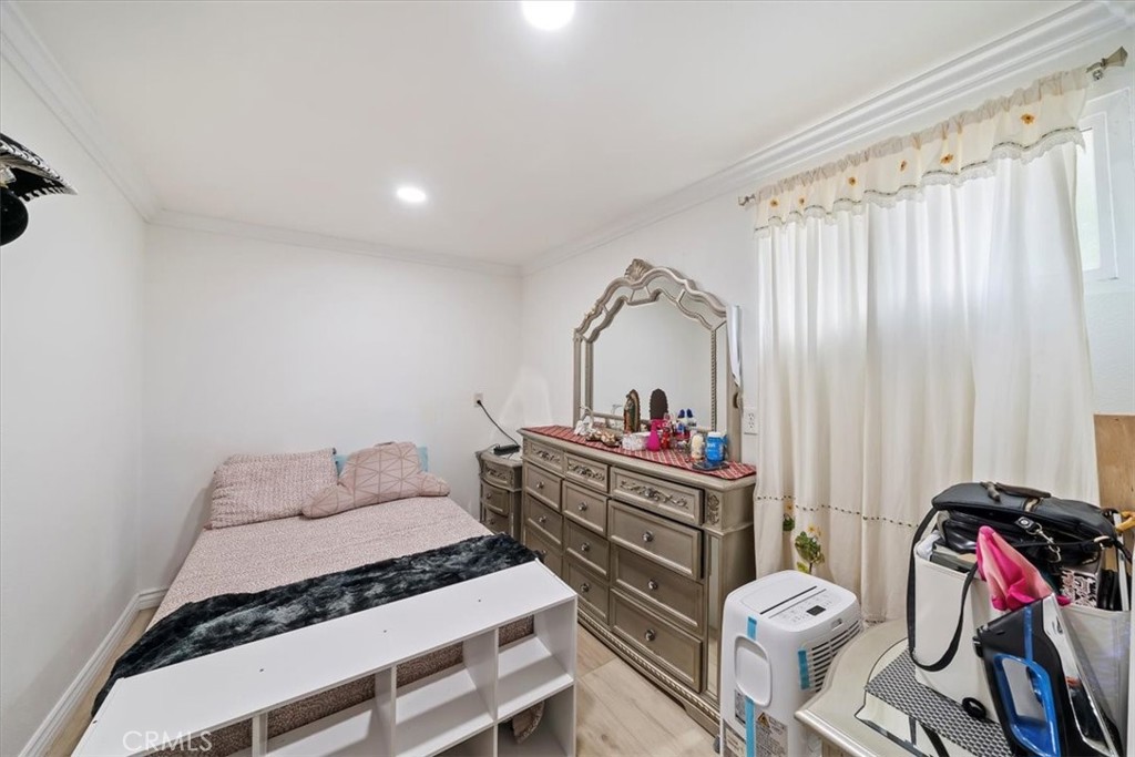 250 North Linden Avenue, Unit 327 Rialto, CA 92376 - Photo 22 of 27 a bedroom with bed and a chandelier