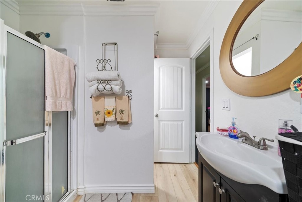 250 North Linden Avenue, Unit 327 Rialto, CA 92376 - Photo 23 of 27 a bathroom with a sink mirror and vanity