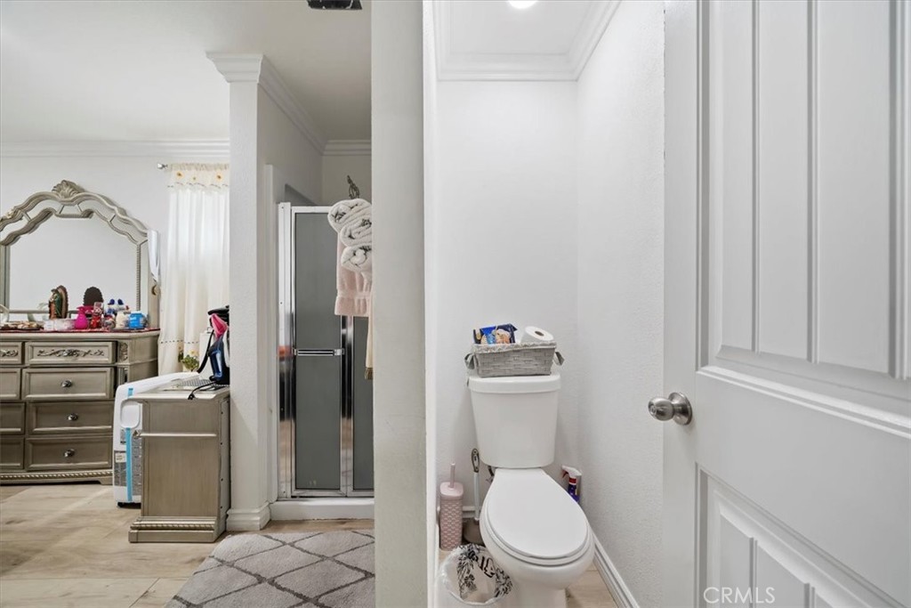 250 North Linden Avenue, Unit 327 Rialto, CA 92376 - Photo 24 of 27 a white toilet sitting next to a bathroom sink and a shower