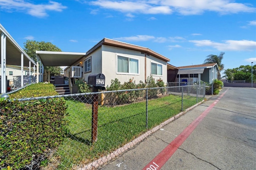 250 North Linden Avenue, Unit 327 Rialto, CA 92376 - Photo 3 of 27 a front view of house with yard and green space