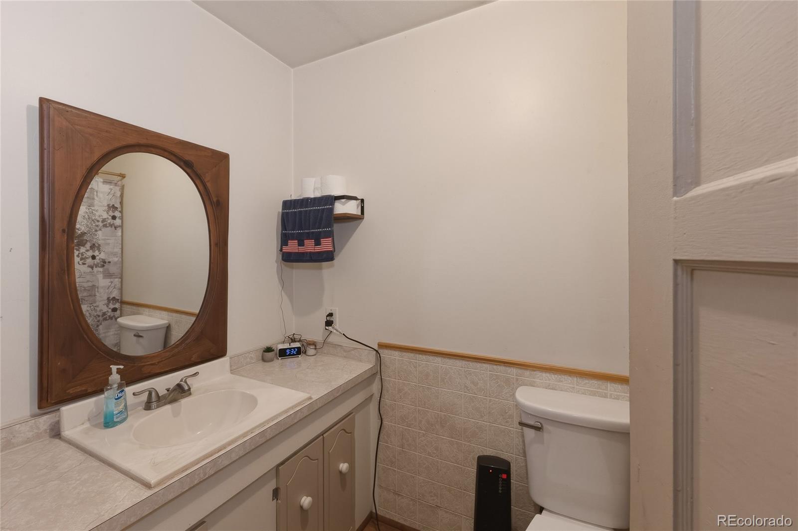 13240 Big Pine Ridge Road Weston, CO 81091 - Photo 16 of 49 a bathroom with a sink mirror vanity and toilet