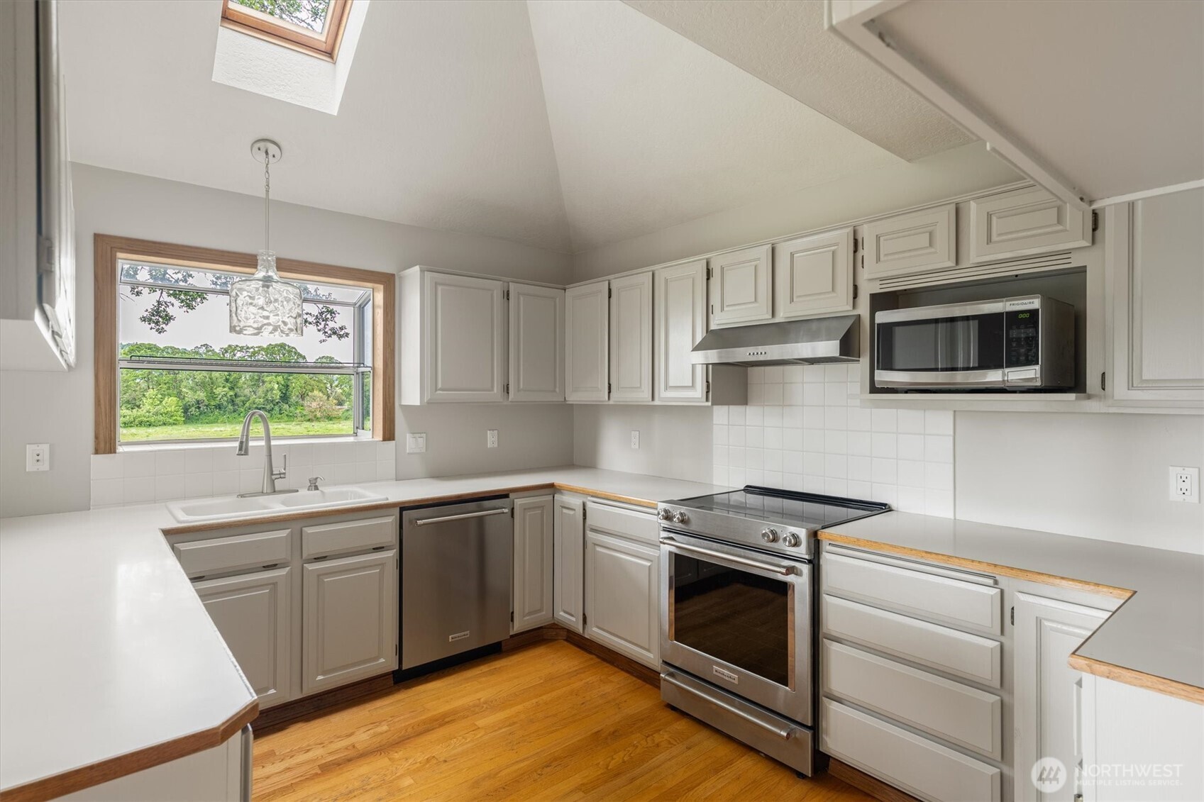 187 Acorn Lane Longview, WA 98632 - Photo 8 of 40 a kitchen with stainless steel appliances a stove sink microwave and window