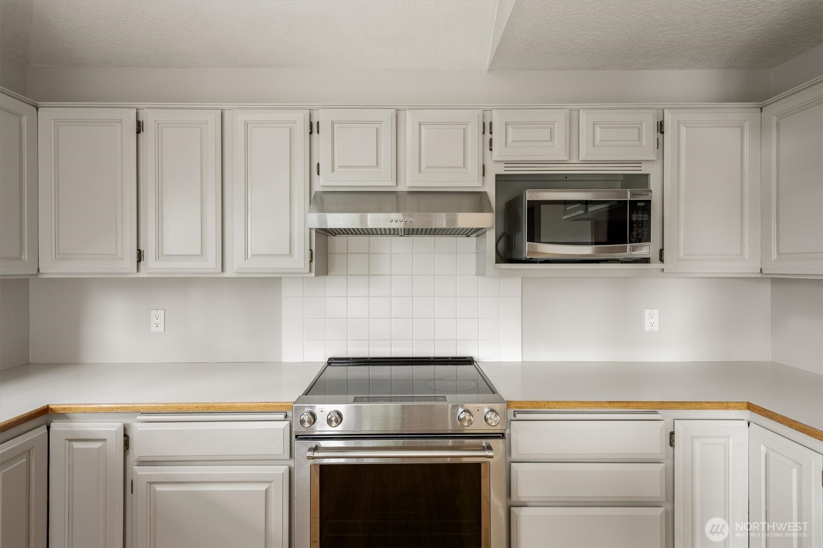 187 Acorn Lane Longview, WA 98632 - Photo 9 of 40 a kitchen with white cabinets and stainless steel appliances