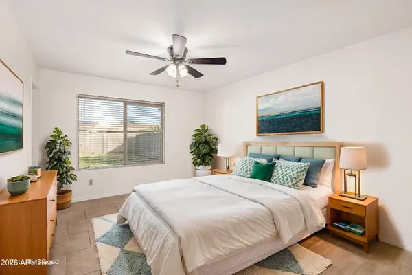 an empty room with windows and fan