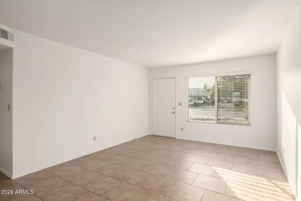 a bathroom with a granite countertop sink and a toilet