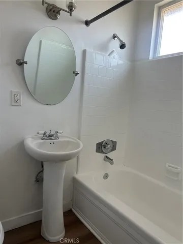 a bathroom with a sink a mirror and a bathtub
