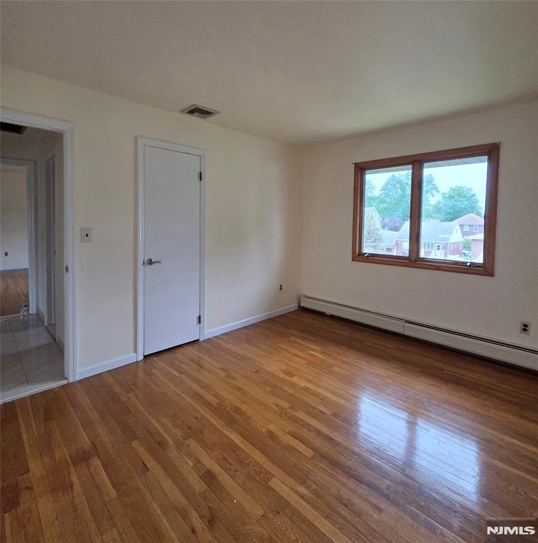 688 Day Avenue, Unit 2 Ridgefield, NJ 07657 - Photo 12 of 18 a view of an empty room with wooden floor and a window