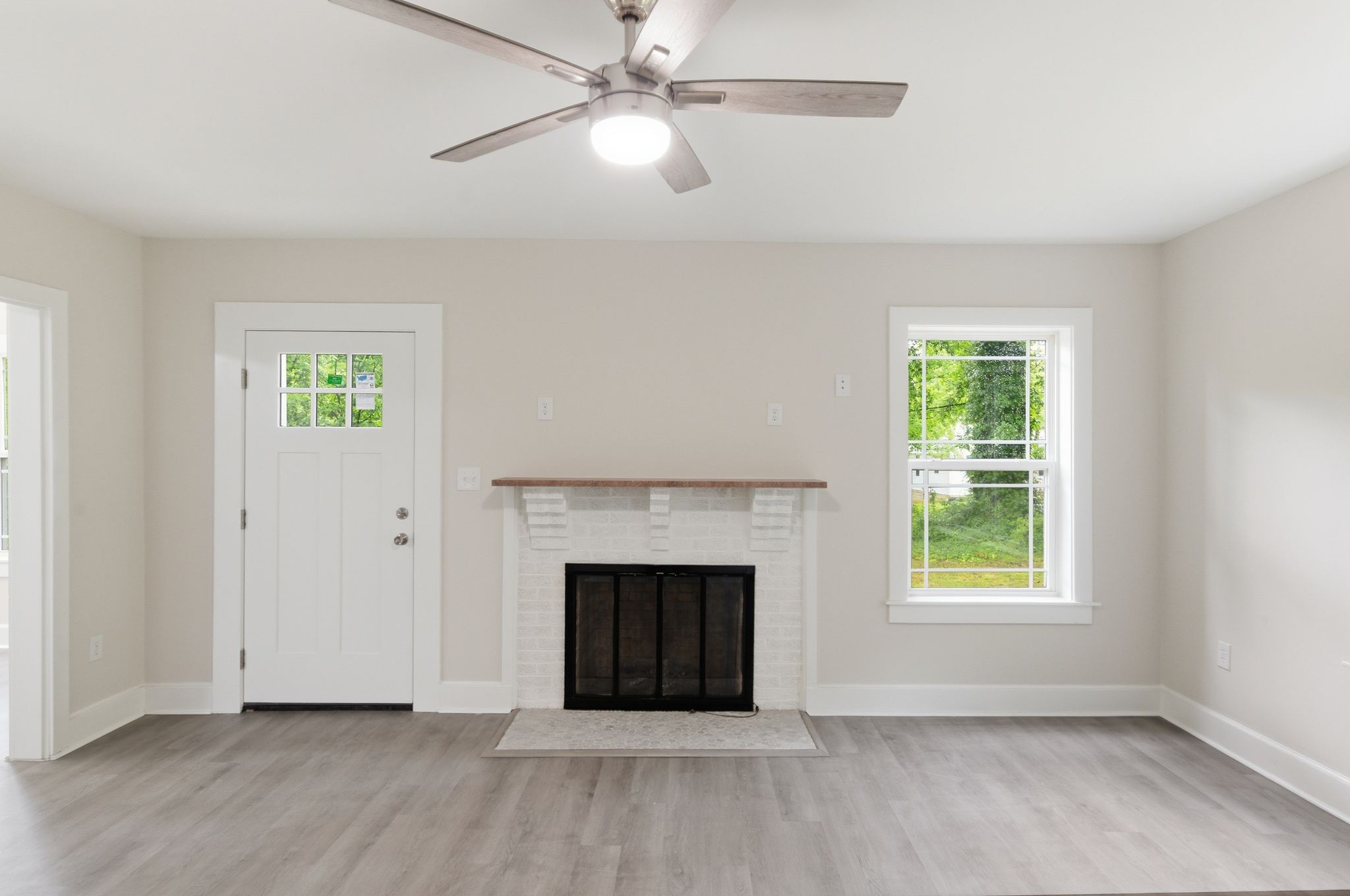 305 South Irwin Street Manchester, TN 37355 - Photo 6 of 40 an empty room with windows and a fireplace