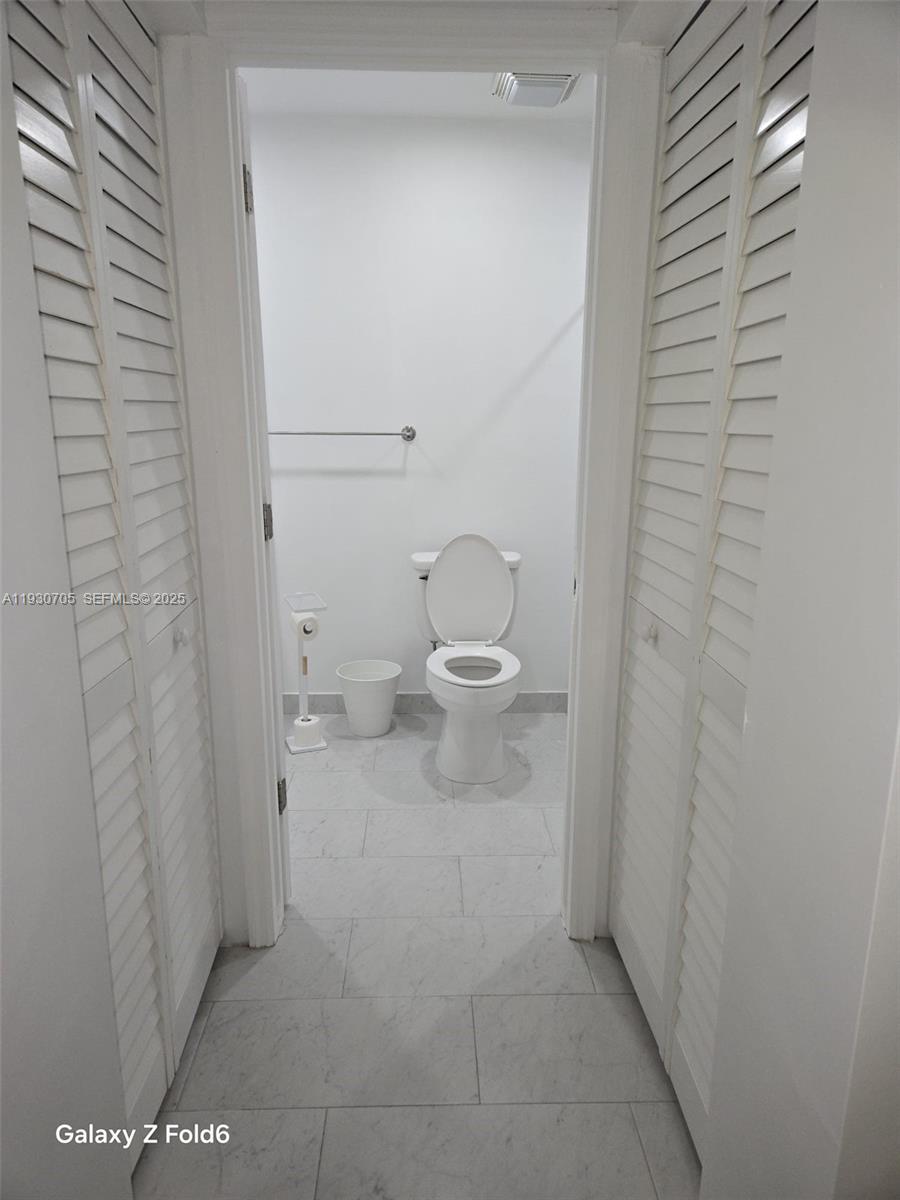 19251 Northwest 61st Avenue, Unit 19251 Hialeah, FL 33015 - Photo 2 of 10 a bathroom with a toilet
