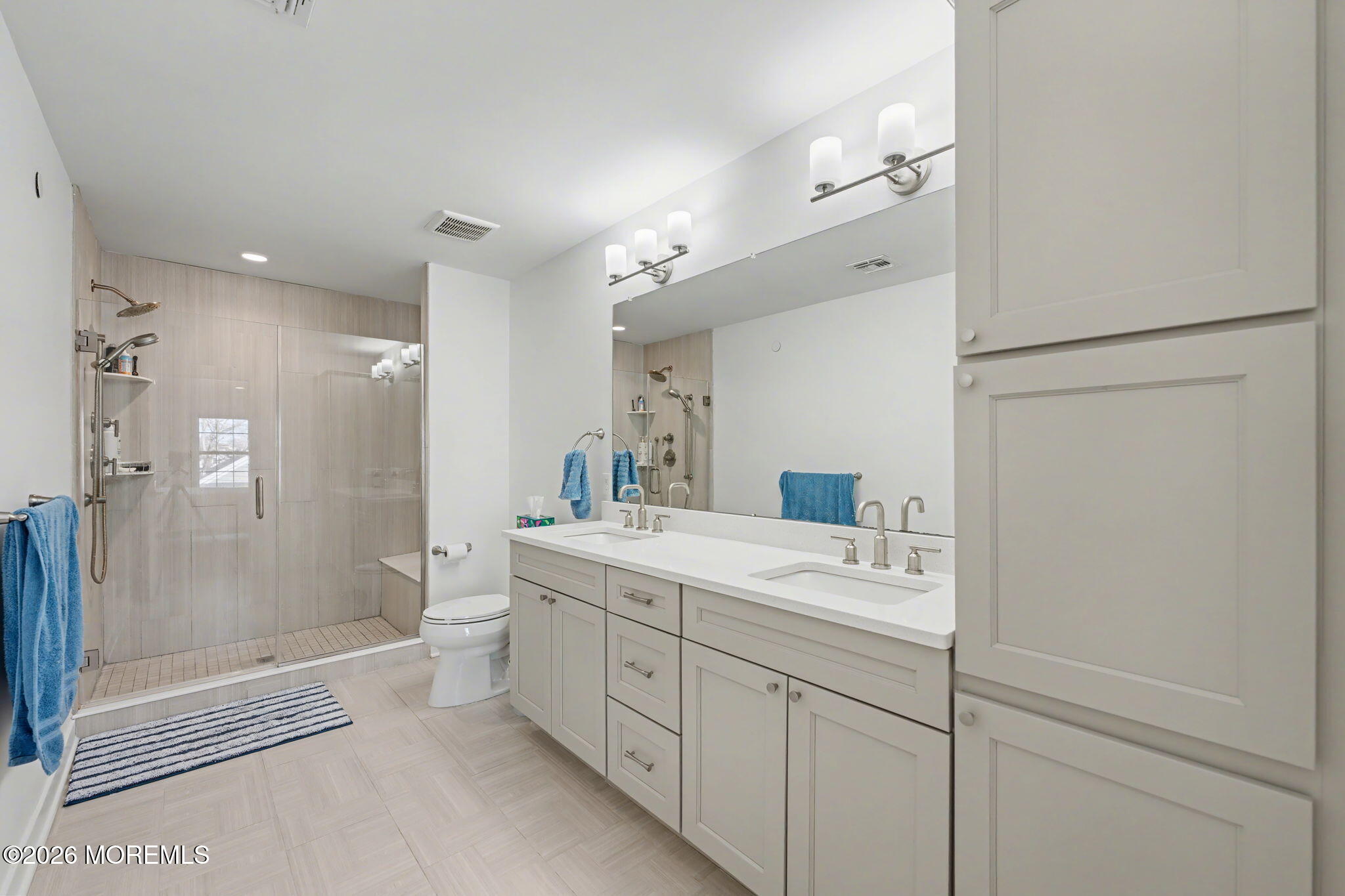 25 Catherine Street, Unit 15 Red Bank, NJ 07701 - Photo 16 of 21 a spacious bathroom with a shower sink and mirror