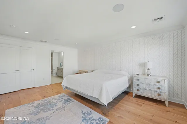 a spacious bedroom with a bed and a couch