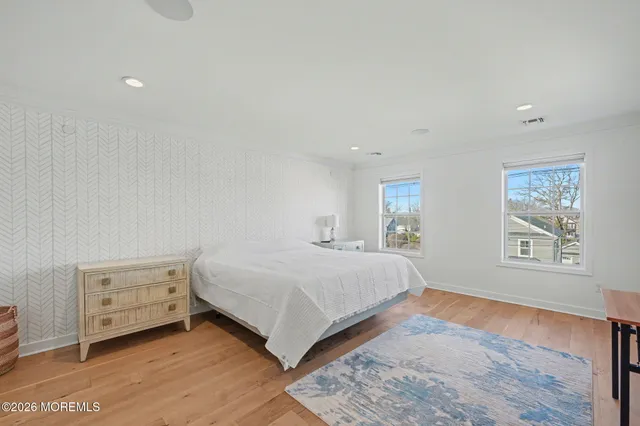 a bedroom with a bed and a night stand