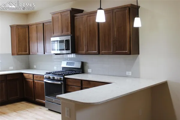 a kitchen with a refrigerator and a sink