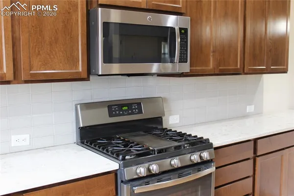 a kitchen with a sink and a stove