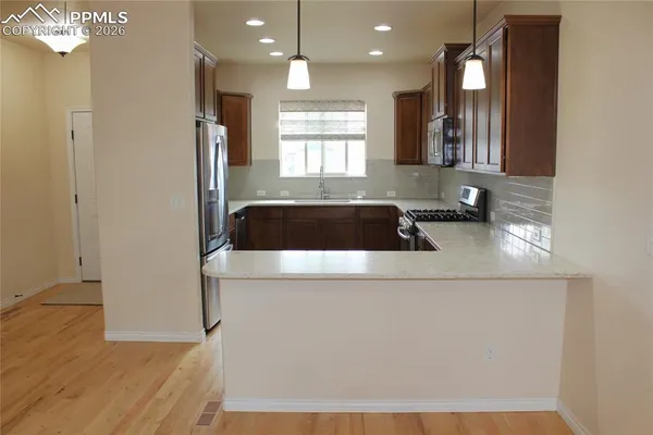 a stove top oven sitting inside of a kitchen