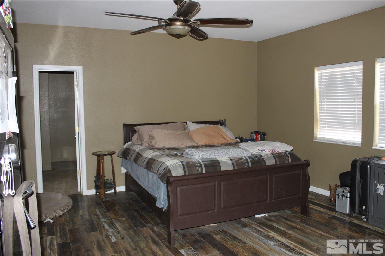 2000 Piute Creek Road Reno, NV 89510 - Photo 12 of 17 a bedroom with a bed and wooden floor