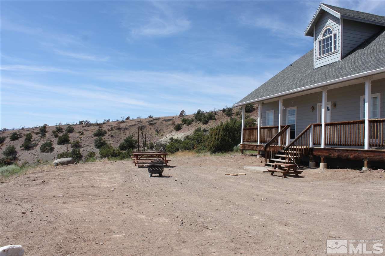 2000 Piute Creek Road Reno, NV 89510 - Photo 5 of 17 a view of a patio with a table and chairs under an umbrella
