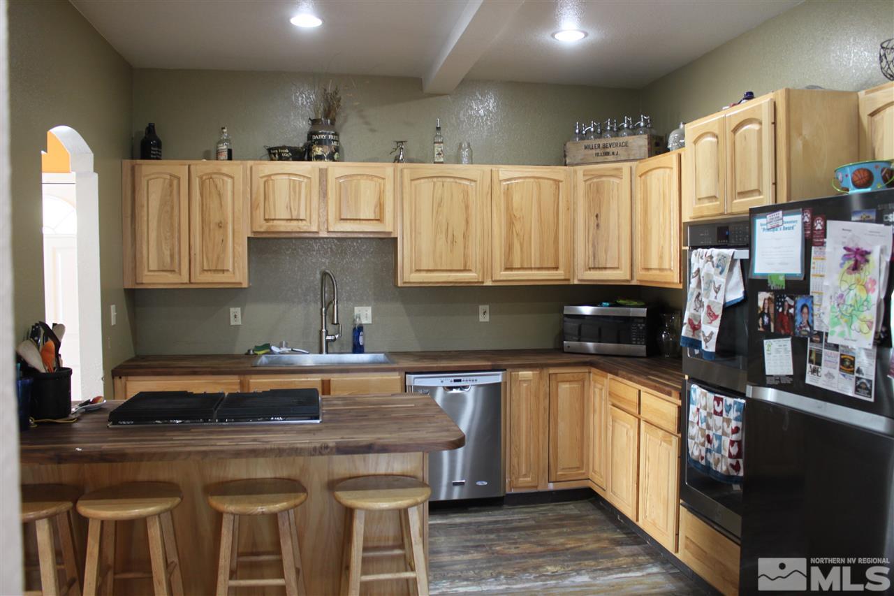 2000 Piute Creek Road Reno, NV 89510 - Photo 6 of 17 a kitchen with kitchen island granite countertop a sink and cabinets