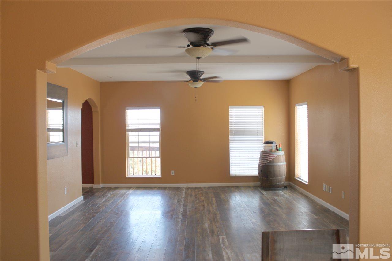 2000 Piute Creek Road Reno, NV 89510 - Photo 8 of 17 an empty room with wooden floor and windows