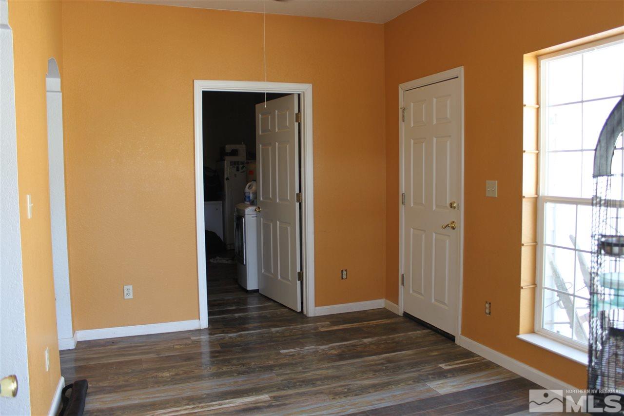 2000 Piute Creek Road Reno, NV 89510 - Photo 10 of 17 a view of an empty room with wooden floor and a window