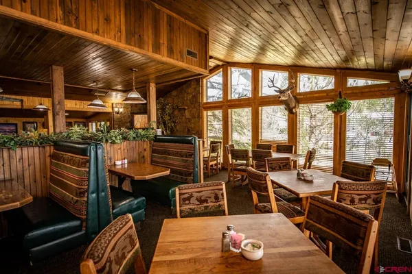 a room with lots of wooden furniture and a window