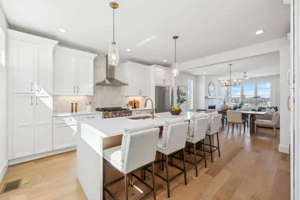 a large kitchen with a table and chairs