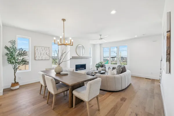 a living room with fireplace furniture and a chandelier