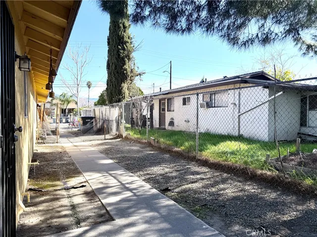 a view of a backyard with plants and a lake view