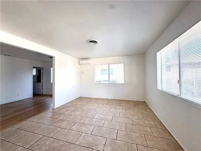 an empty room with windows and entrance