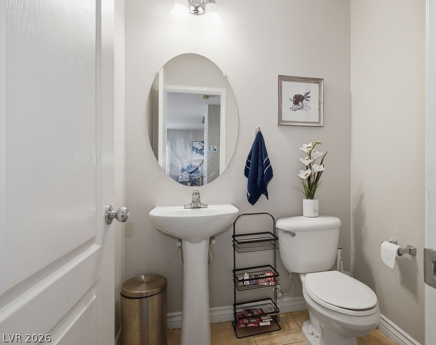 3409 Edinboro Ridge Avenue North Las Vegas, NV 89081 - Photo 12 of 51 Downstairs half bath w/ pedestal sink, tile flooring & oval mirror