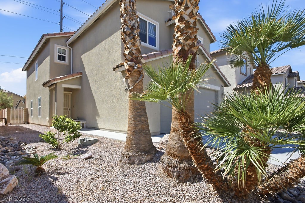 3409 Edinboro Ridge Avenue North Las Vegas, NV 89081 - Photo 36 of 51 View to front door entry-low maintenance landscaping & palm trees.