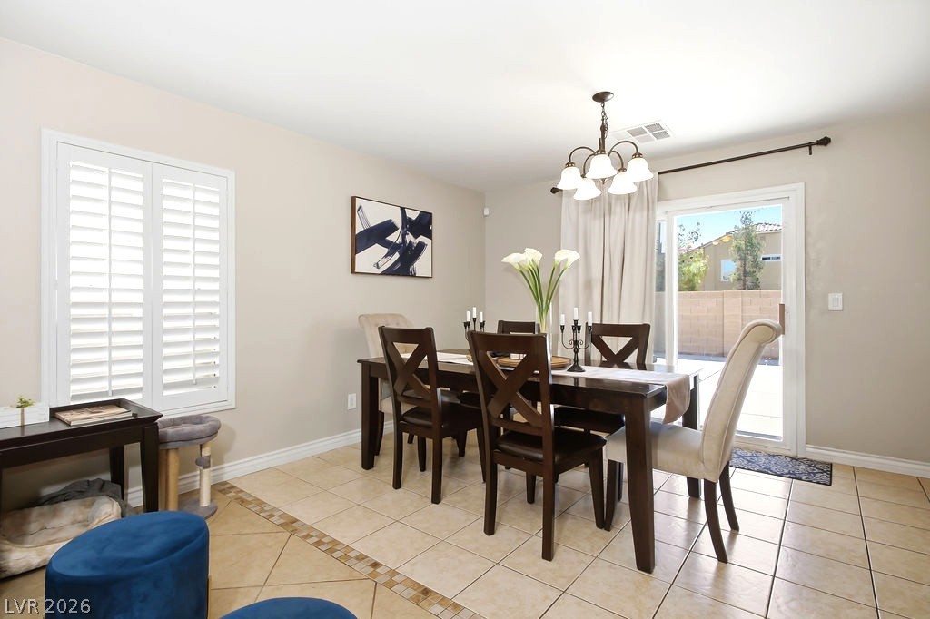 3409 Edinboro Ridge Avenue North Las Vegas, NV 89081 - Photo 5 of 51 The dining area window features plantation shutters & chandelier lighting