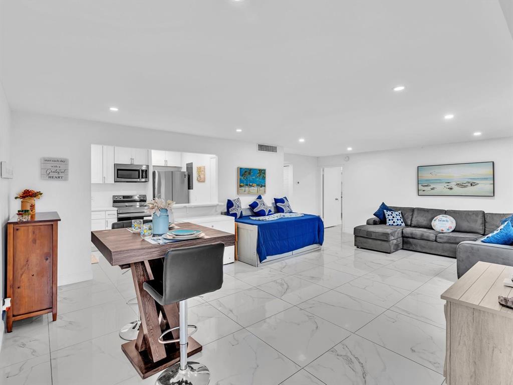 5100 Dupont Boulevard, Unit 8G Fort Lauderdale, FL 33308 - Photo 15 of 65 a living room with furniture a table and kitchen view