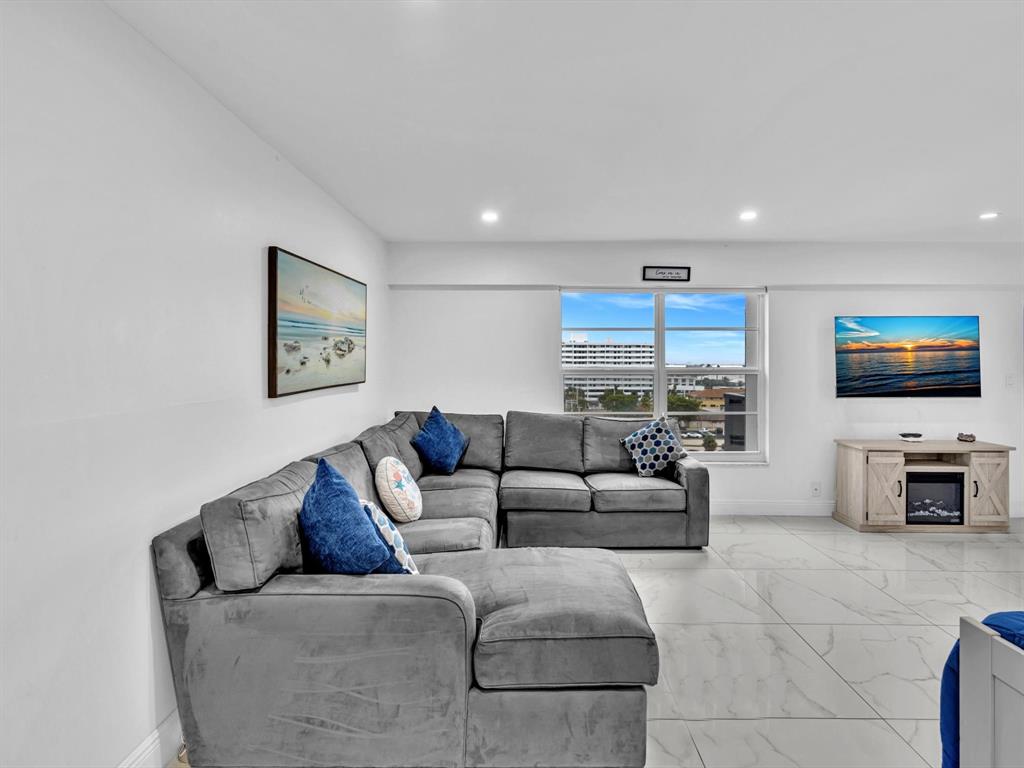 5100 Dupont Boulevard, Unit 8G Fort Lauderdale, FL 33308 - Photo 2 of 65 a living room with furniture and a flat screen tv