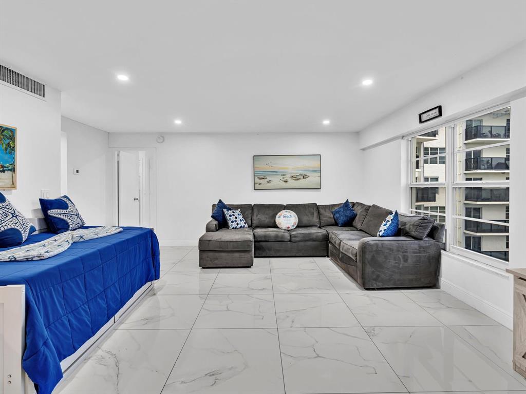 5100 Dupont Boulevard, Unit 8G Fort Lauderdale, FL 33308 - Photo 31 of 65 a living room with furniture and a book shelf