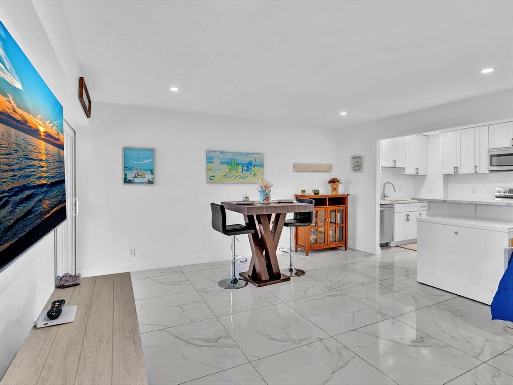 5100 Dupont Boulevard, Unit 8G Fort Lauderdale, FL 33308 - Photo 7 of 65 a view of a kitchen with fridge and workspace